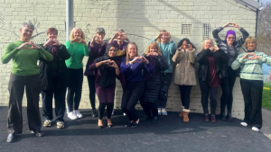 LWA staff smiling and making heart shape with their hands